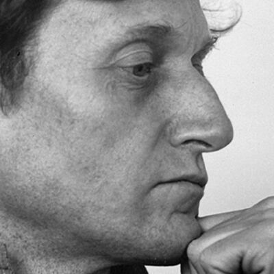 A side-profile portrait of French composer Gérard Grisey looking pensive