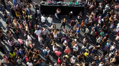 Ariel view of a crowd of people dancing around Dj set playing vinyl records