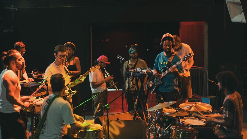 A group of musicians, playing a range of instruments.