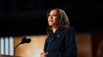 An image of Kamala Harris looking out from a speakers' podium