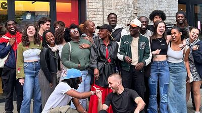 Group of people in various outfits laughing and enjoying each other's company