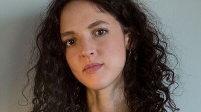 Isabella Hammad wearing a grey shirt and black top.