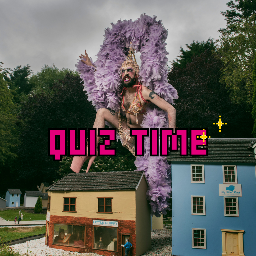 A person wearing a purple feathered headpiece, standing on miniature houses