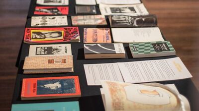 Photograph of a table covered in poetry books.