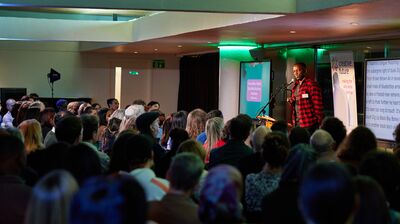 Performer onstage speaking at an event.