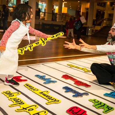 Girl playing with the Alphabet Soup installation at Southbank Centre.