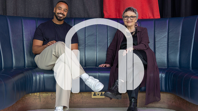 Linton Stephens and Gillian Moore sit side by side on a leather seat in the Southbank Centre's Queen Elizabeth Hall Foyer