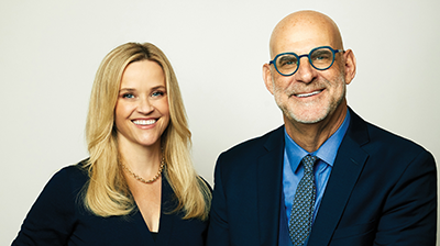 Reese Witherspoon and Harlan Coben posing together.