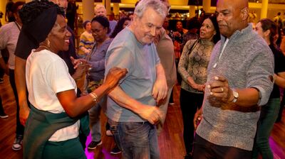 a group of older adults of mixed genders dancing together at a Mix & Move event