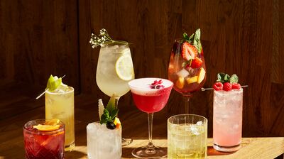 Row of cocktails on wooden table