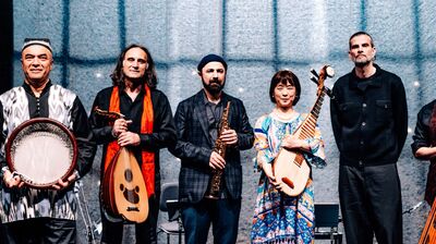 Colourful image of Aga Khan musicians holding their instruments