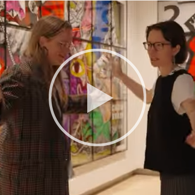 Two people standing in different poses.