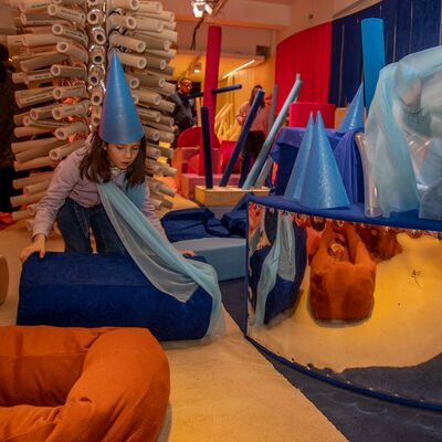 Children playing in a loose parts play installation
