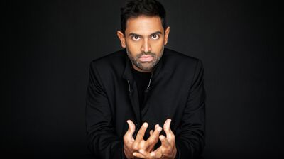 Portrait of Conductor Harish Shankar wearing a Black Suit