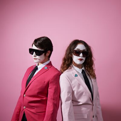 Sh!t Theatre: EVITA TOO actors wearing pink and fuchsia suits