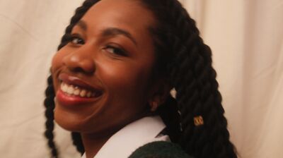 Smiling woman with rope braids.