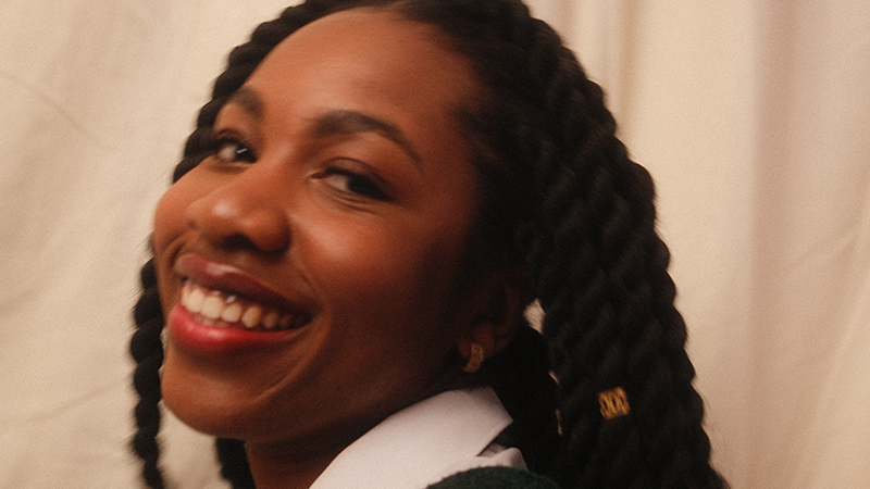 Smiling woman with rope braids.