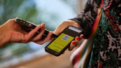 One person holding their mobile device and having a QR coded scanned for the Southbank centre membership