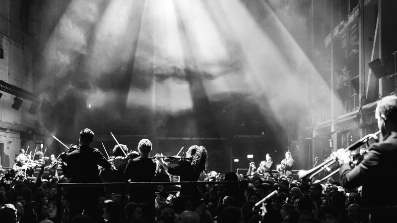 Aurora Orchestra perform amongst the audience in an immersive concert