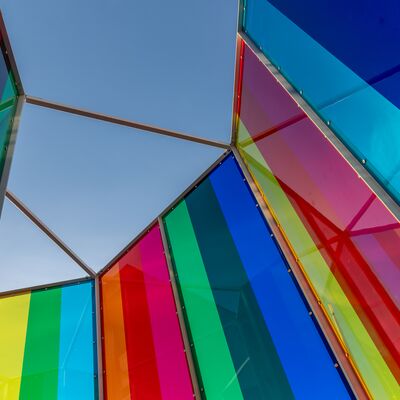 A view from inside a colourful light instillation on the riverside terrace.