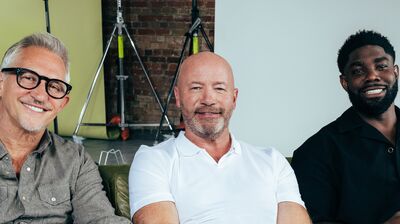 The Rest is Football hosts sitting together and smiling.