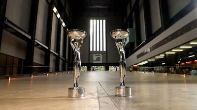 Image of two Booker trophies standing in the foyer of the Tate Modern.