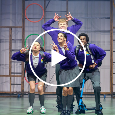 A group of kids in school uniform pose together.