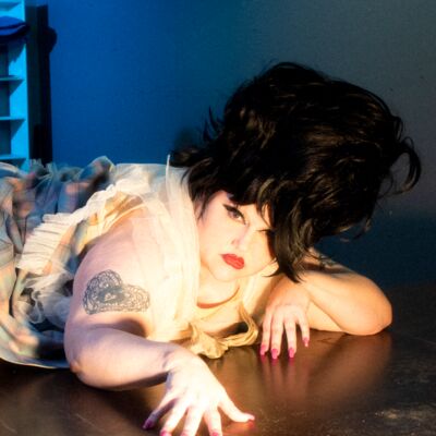 a woman with with black hair in a beehive style looking straight ahead