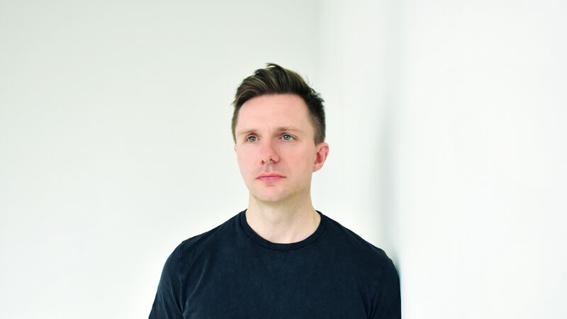 Portrait of James McVinnie, wearing a black t shirt