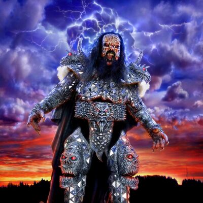 Mr. Lordi dressed as a grotesque zombie wearing shiny metallic armour, stood in front of an apocalyptic landscape