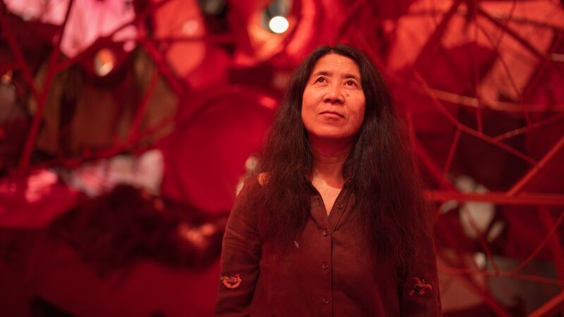 The artist Yin Xiuzhen stands win front of her installation A Heart to Heart in the Hayward Gallery exhibition of the same name.