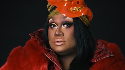 Drag queen Mahatma Khandi looks at camera.