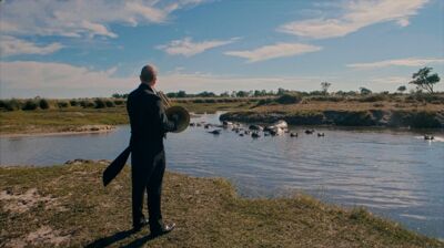 French Horn player by a hippo pond in Botswana
