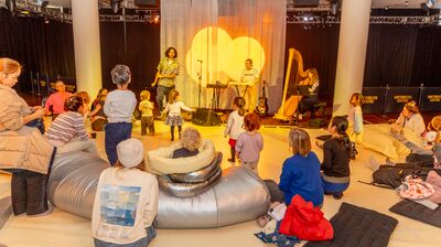 a group of children looking at a band performing