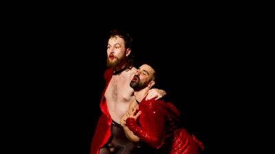 Four performers stand on a stage