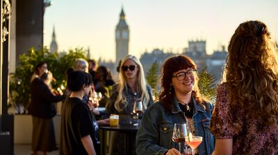 People drinking on a balcony bar