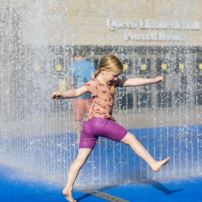 A child playing in the fountain