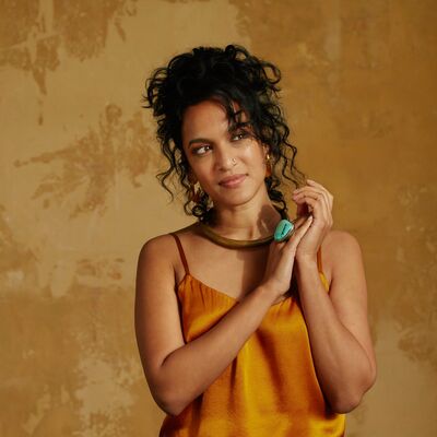 British-American sitar player and musician Anoushka Shankar, wearing an orange top
