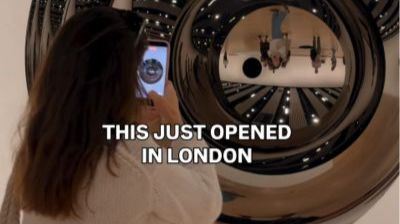 Person taking a selfie in a metallic sculpture