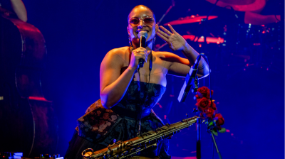 Nubya Garcia smiling with her hand to her ear