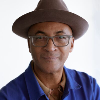 Colin Grant wearing a blue shirt and brown hat.