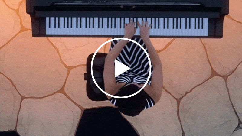 A slow moving gif showing Yuja Wang playing the piano from above