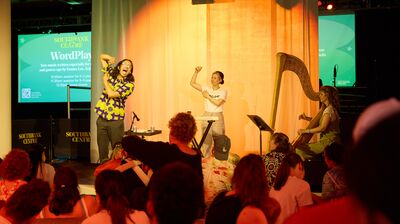 Two people on stage infront of families