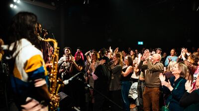 An audience giving a band a standing ovation.