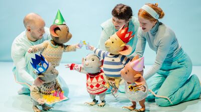 Five mouse puppets wearing jumpers and paper crowns cheers with drinks