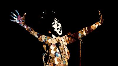 Silhouette of a singer with arms raised, composed of shimmering gold sequins against a solid black background.