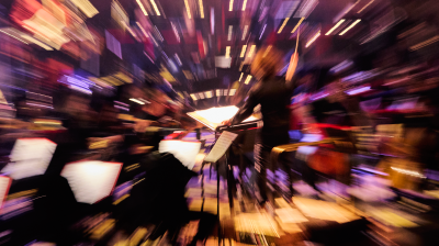 A zoom effect distorts the picture and lights while an orchestra plays