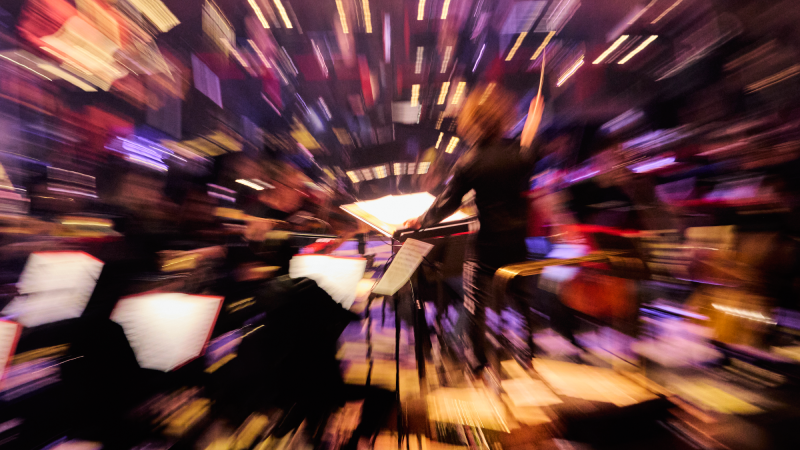 A zoom effect distorts the picture and lights while an orchestra plays
