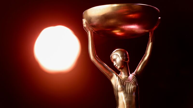 Booker Prize Trophy with a red light in the background.