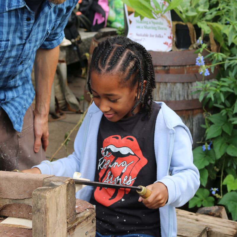 Child participating in a workshop on the roof garden.